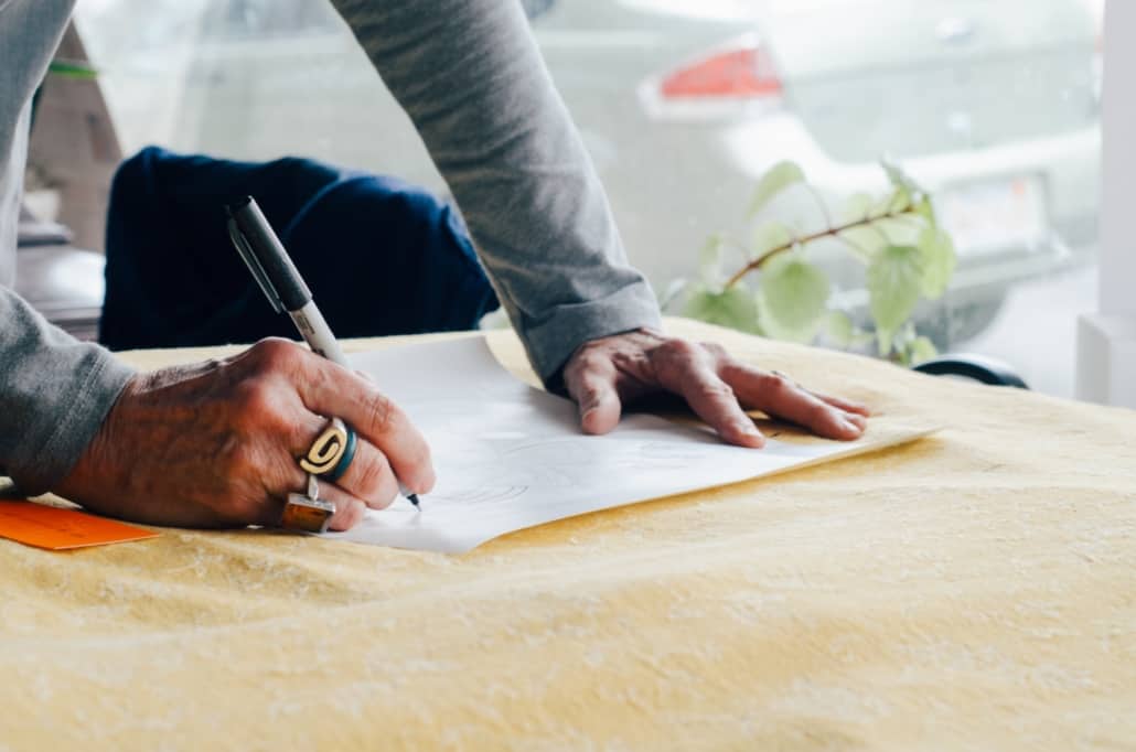 older person signing a trust agreement