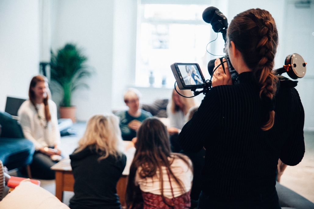 self-employed videographer filming a meeting