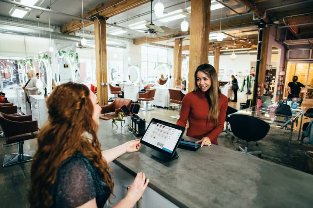 two office workers discussing small business tax deduction