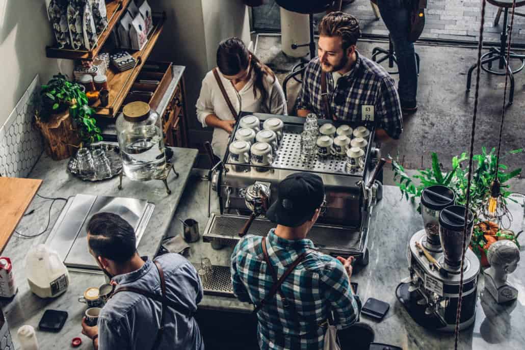 Patrons at a coffee shop discussing the CEBA loan repayment deadline extension