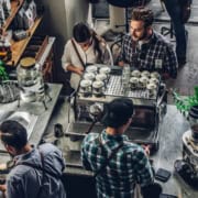 Patrons at a coffee shop discussing the CEBA loan repayment deadline extension