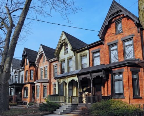Row of old Victorian style brick houses with gables illustrating Underused Housing Tax extended again